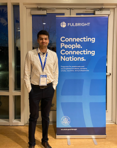 Fulbright Enrichment Seminar on Entrepreneurship, standing in front of a sign that says Fulbright, Connecting People. Connecting Nations. 